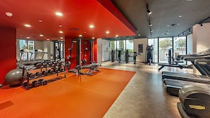 A gym with treadmills, weight machines, and free weights. - Luxury La Mer 1BR | Balcony Sea Views + Near City Walk & Mall (Dubai)