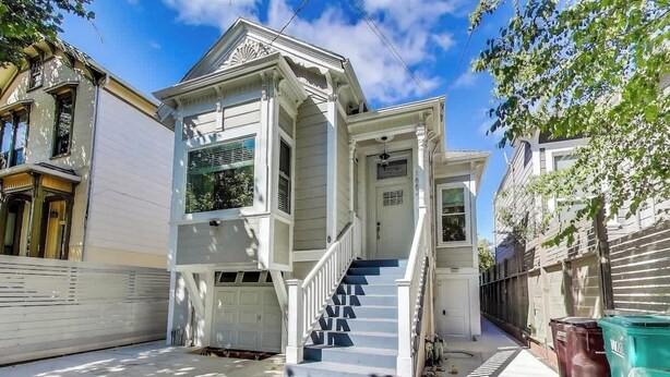 A two-story house with a front porch, a staircase, and a garage.