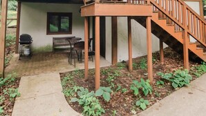 A two-story house with a balcony and a covered patio area. - ModCabin Escape - Ski In/Out +Heated pool Avail! (Boyne Falls)