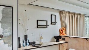 A modern kitchen with a wooden countertop, a black vase, a wine bottle, and a black bowl. - Space shuttle around mountains - Geometry Park (Agios Theodoros)