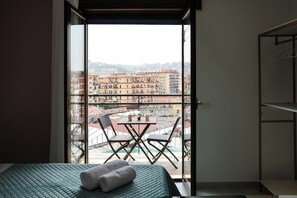 Room with green bed | Balcony