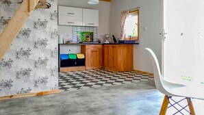 A kitchen with wooden cabinets, a checkered floor, and a white chair. - Gorgeous home in Ilawa with WiFi (Ilawa)