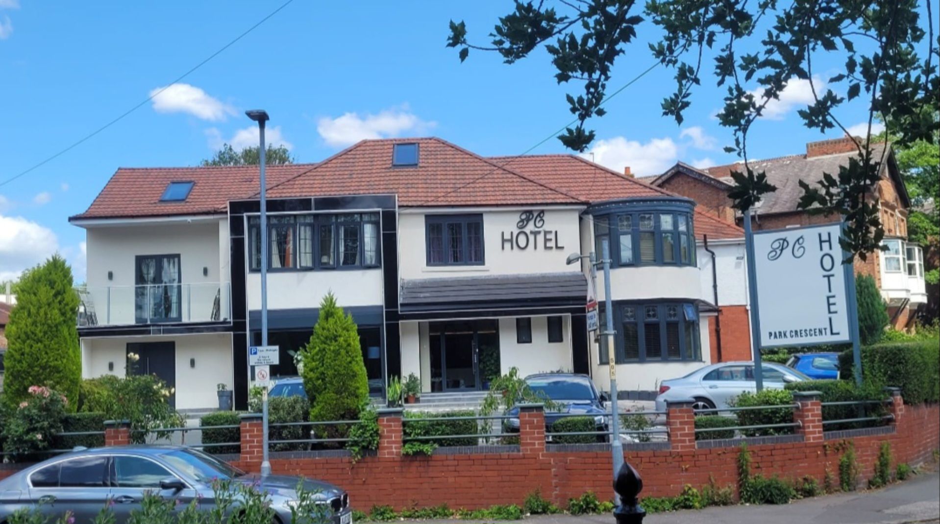A two-story hotel with a sign indicating it is a Park Crescent hotel.