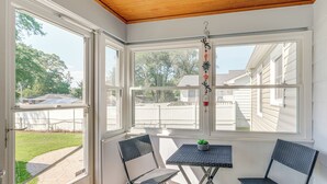 A sunroom with a wooden ceiling, large windows, and two chairs with a small table. - < 1 Mi to Colonial Beach: Coastal Gem w/ 2 Porches (Colonial Beach)