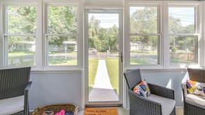 A room with wicker furniture, a door leading outside, and a 'BEACH' sign above the door. - < 1 Mi to Colonial Beach: Coastal Gem w/ 2 Porches (Colonial Beach)