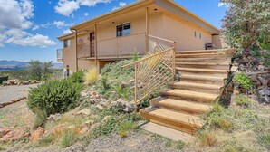 A two-story house with a wooden staircase leading to a balcony. - Panoramic Vistas and Spacious: Silver City Escape (Silver City)