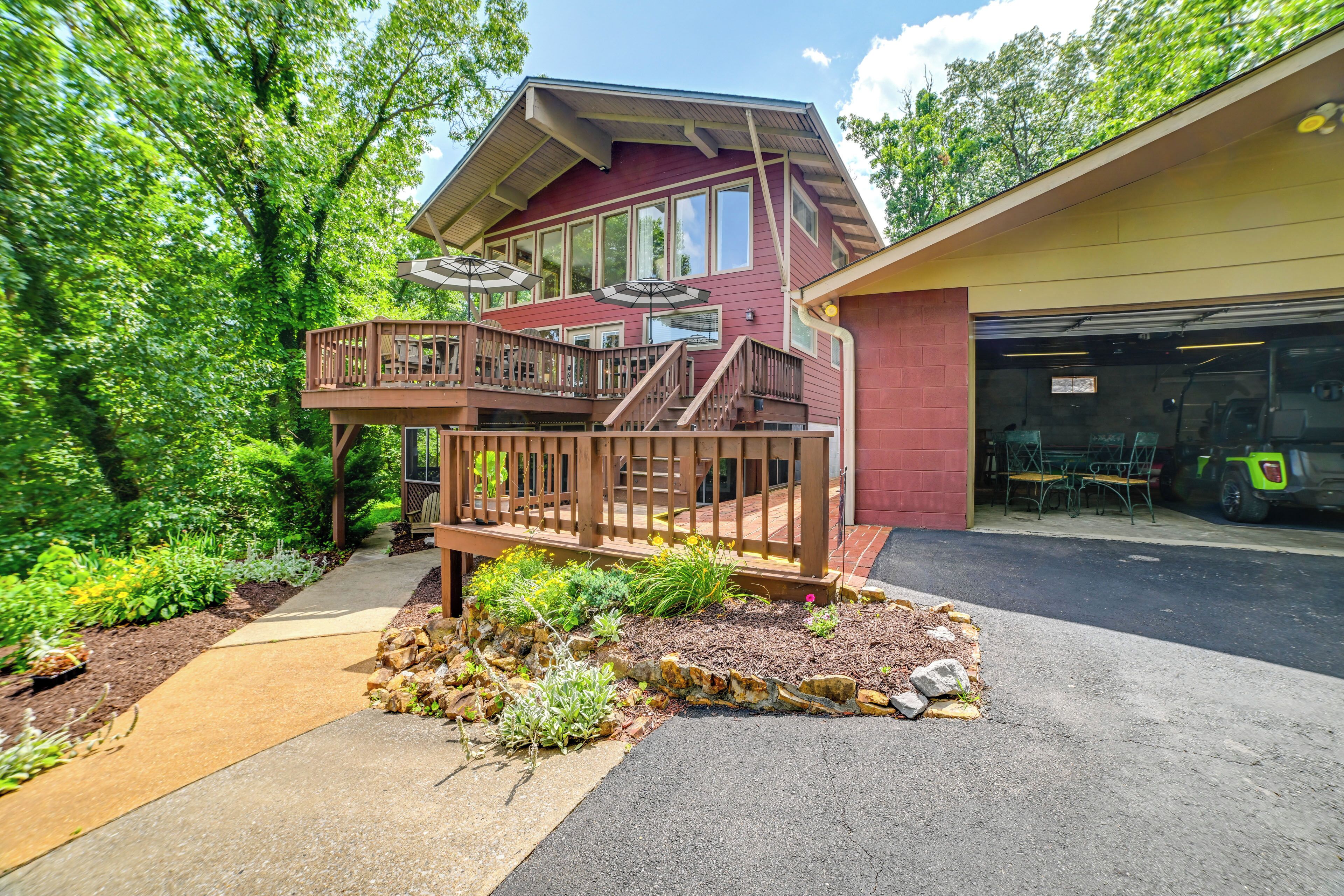 A two-story house with a wooden deck and a garage.