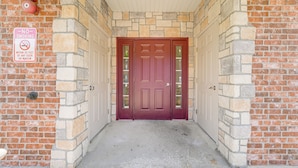 A red door with a glass panel, a 'No Smoking' sign, and a brick wall. - 'groovy Games Getaway' Holiday Stay in Branson! (Branson)