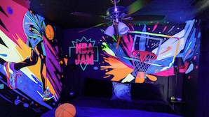 A room with a basketball theme, including a basketball hoop and a wall with a basketball player illustration. - 'groovy Games Getaway' Holiday Stay in Branson! (Branson)
