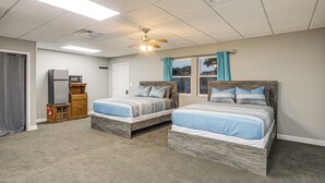 A bedroom with two beds, a ceiling fan, a microwave, and a small wooden cabinet. - Shared Outdoor Space: Quaint Studio in Fredonia (Fredonia)
