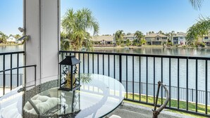 A balcony with a glass table, cushions, and a lantern. - 3 Mi to Main St Tracy: Homey Retreat w/ Game Room! (Tracy)