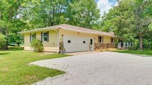 A single-story house with a garage, surrounded by a well-maintained lawn and trees. - 9 Mi to Downtown Rushville: Cozy Getaway w/ Grill (Rushville)