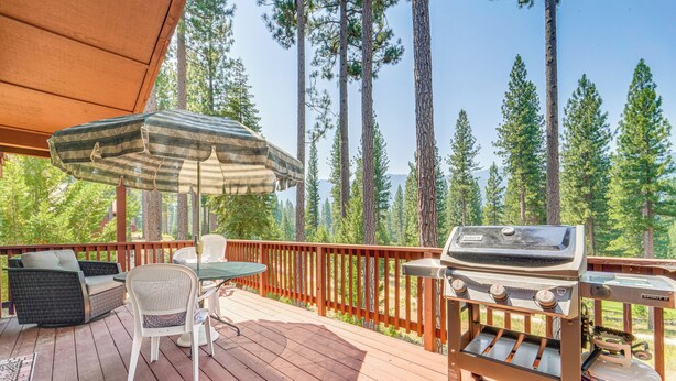 A wooden deck with outdoor furniture, a grill, and a propane tank. - Golf & Mountain Views - Retreat in Clio (Clio)