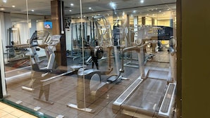 A gym with various exercise machines, including treadmills and weight machines, arranged in a spacious layout. - 1 Bedroom Apartment with City Skyline Views (Pyrmont)
