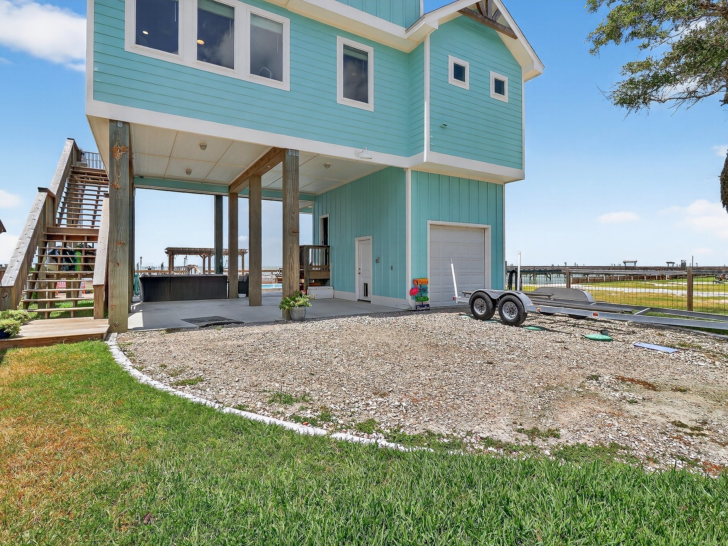 A two-story house with a covered porch, a garage, and a small outdoor deck.