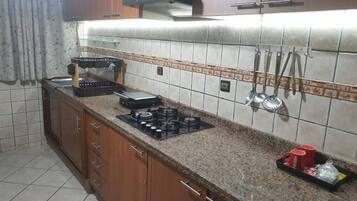 Fridge, coffee/tea maker, blender, cookware/dishes/utensils