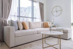 Luxury Apartment, City View | Living area | 65-inch Smart TV with cable channels