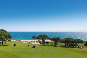 A golf course with a view of the ocean and beach.