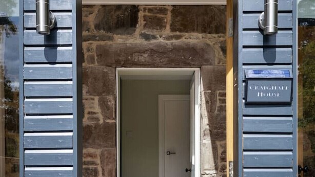 A doorway leading into a room with a stone wall and wooden flooring. - Craighall House, Stunning River Tay Views & Garden (Stanley)