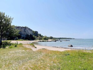 A coastal landscape with a cliff, beach, and calm sea. - 4 Star Holiday Home in Visby (Visby)