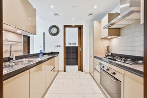 Exclusive Apartment, Balcony, City View | Private kitchen | Full-size fridge, microwave, oven, stovetop - PVH - Serene 2BR - Sobha Hartland Greens (Dubai)