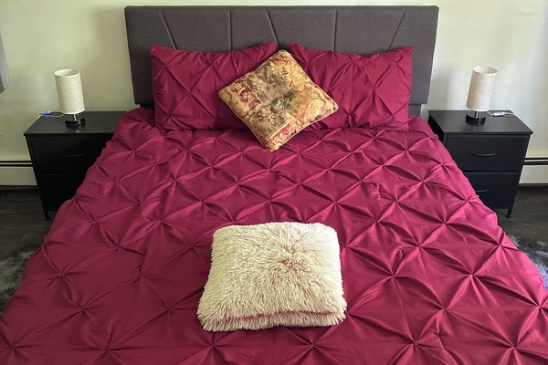 Main bedroom with queen bed overlooking the peaceful backyard for peaceful stay