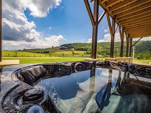 A hot tub with a clear view of a green landscape and hills in the background. - Brand New | Hot Tub + Grandfather Mtn + Views (Banner Elk)