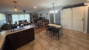 Une cuisine spacieuse avec un coin repas, des meubles en bois et un grand îlot central.
