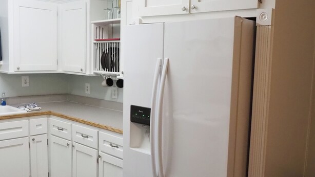 A kitchen with white cabinets, a built-in refrigerator, and a countertop. - R&R Retreat w/Lake Access. Grand Lake Grove, OK (Wyandotte)