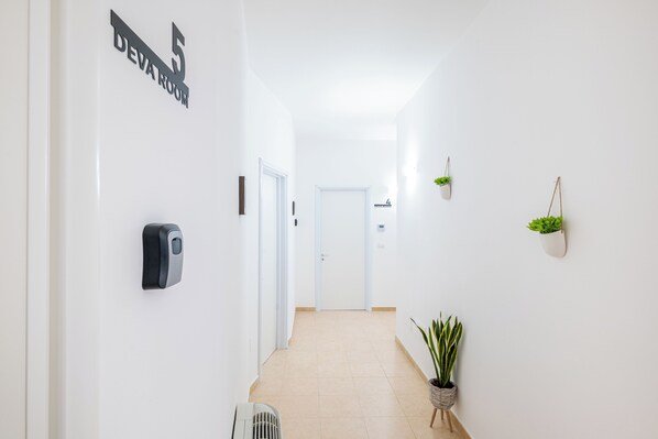 A hallway with a sign reading "DEVA ROOM" and a door labeled "4".