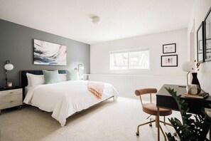A bedroom with a bed, bedside table, lamp, desk, chair, and artwork on the walls. - Golden Foothills | Hot Tub | Hiking & Biking! (Golden)