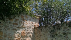 A stone-walled pool area with clear water, surrounded by greenery and a clear sky. - Charming, quiet house with patio and pool. Surrounding countryside (Sabran)