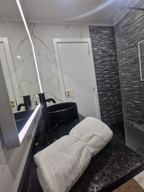 Bidet, towels, soap, toilet paper