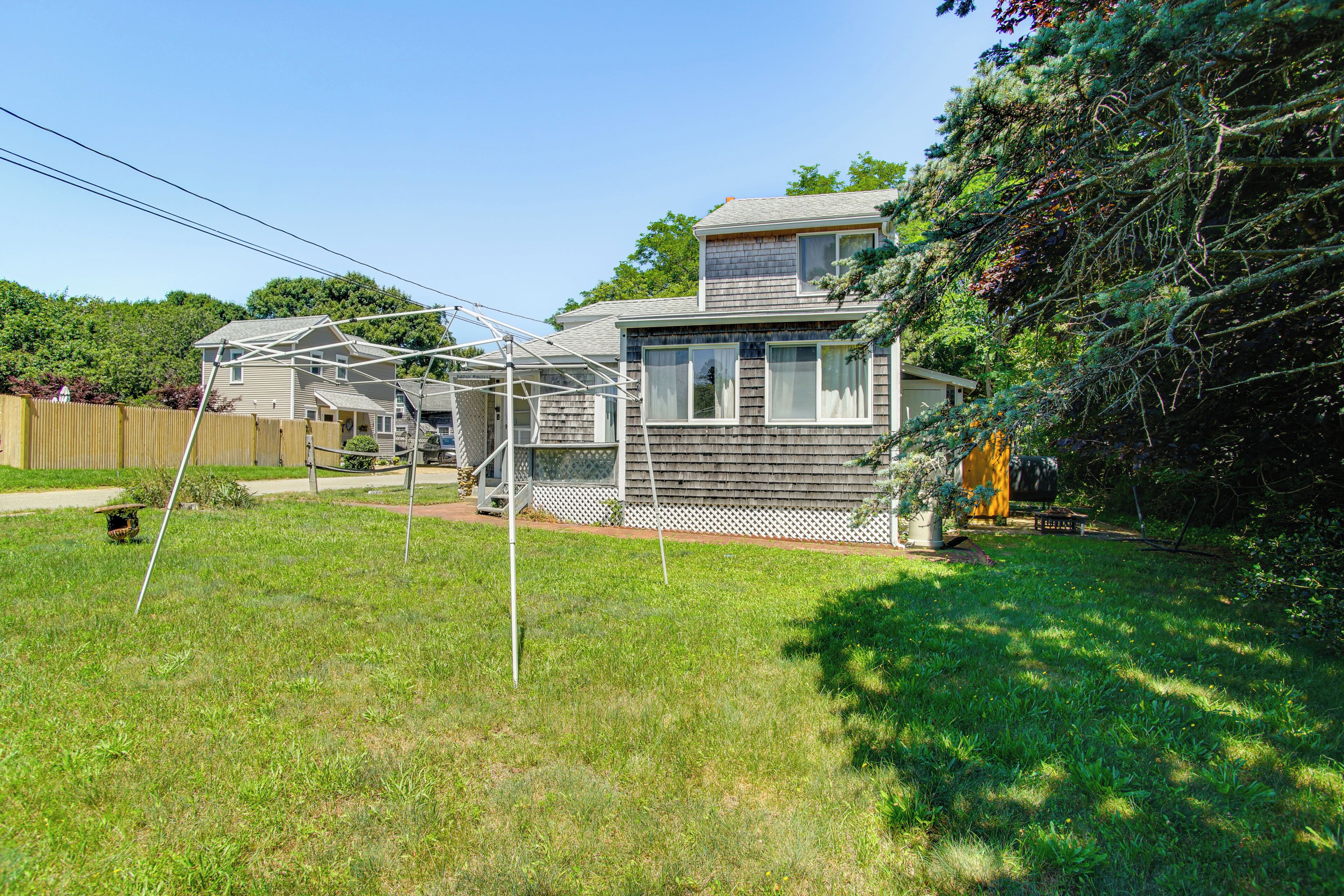 A two-story house with a covered patio and a fenced yard.