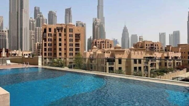 A swimming pool with a view of high-rise buildings in the background.
