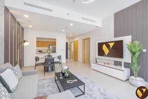Luxury Apartment, Canal View | Living area | 65-inch Smart TV with cable channels