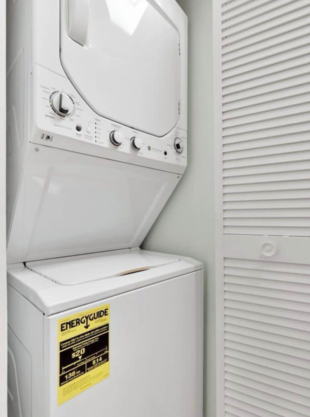 A front-loading washer and dryer unit with an ENERGYGUIDE sticker.