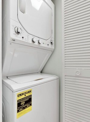 Un appareil combiné lave-linge et sèche-linge à chargement frontal, muni d’une étiquette ENERGYGUIDE.