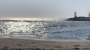 A beach with a row of black lounge chairs facing the ocean. - One Bedroom Apartment  fully furnished with AC in charming Qerret Beach, Albania (Qeret)