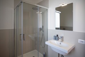 Habitación cuádruple, balcón, vista al jardín | Baño | Regadera, toallas, jabón, shampoo