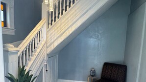 A staircase with white balusters and a dark wooden floor.