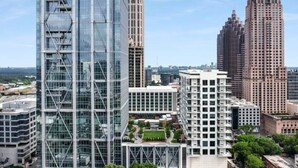 A modern high-rise building with a glass facade and a unique geometric design. - Royal Escape Midtown High Rise (Atlanta)
