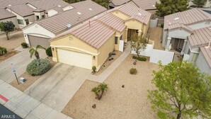 A residential area with multiple houses, each featuring a similar architectural style with pitched roofs and attached garages.