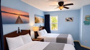 A hotel room with two beds, a ceiling fan, a window with a view, and wall art. - Ocean blue Paradise, Perfect Location. (Myrtle Beach)