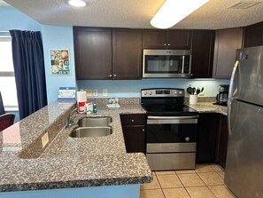 Stovetop, dishwasher, coffee/tea maker, cookware/dishes/utensils