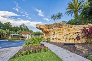 A landscaped entrance with a rock wall and the words "Terra Verde" carved into it. - Summer Escape • Resort Amenities • Private Pool • Lakeview • Near Disney (Kissimmee)