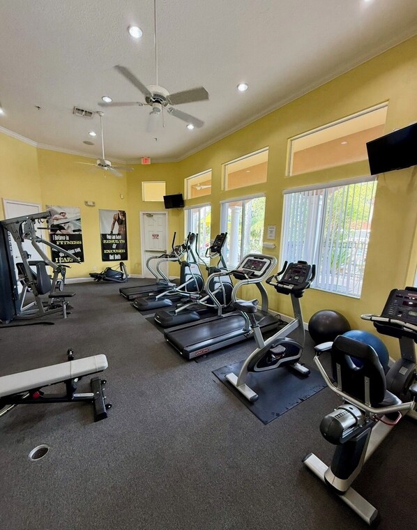 A gym with treadmills, elliptical machines, and weight equipment. - Summer Escape • Resort Amenities • Private Pool • Lakeview • Near Disney (Kissimmee)