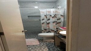 A bathroom with a tiled floor, a toilet, a sink, and a shower curtain. - Casa Tropicalissimo Isla Mujeres. located in the Colony, 5 Persons (Isla Mujeres)