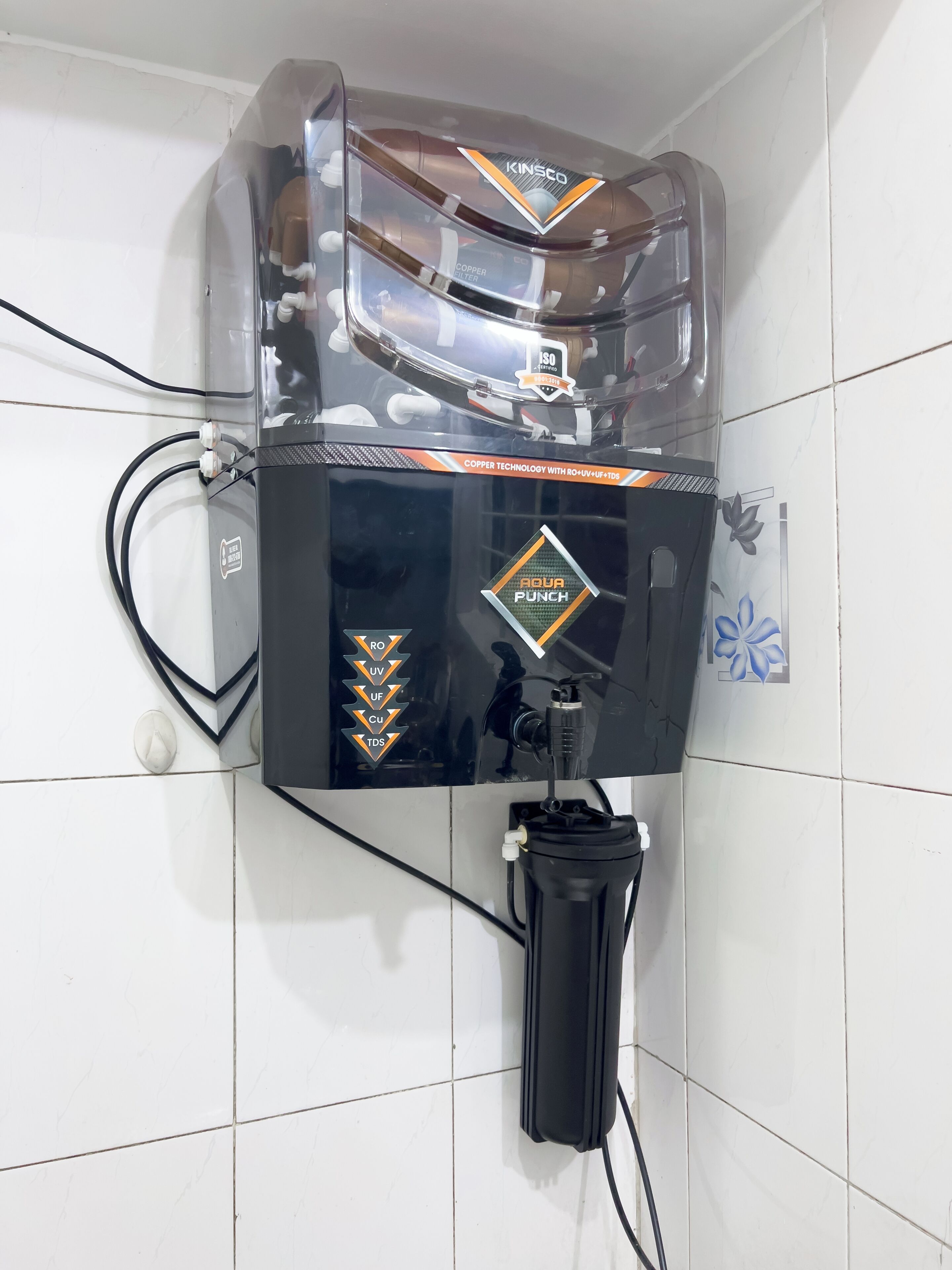 Un système de filtration d’eau doté d’un couvercle transparent en plastique, d’étiquettes de marque et d’un câble d’alimentation.