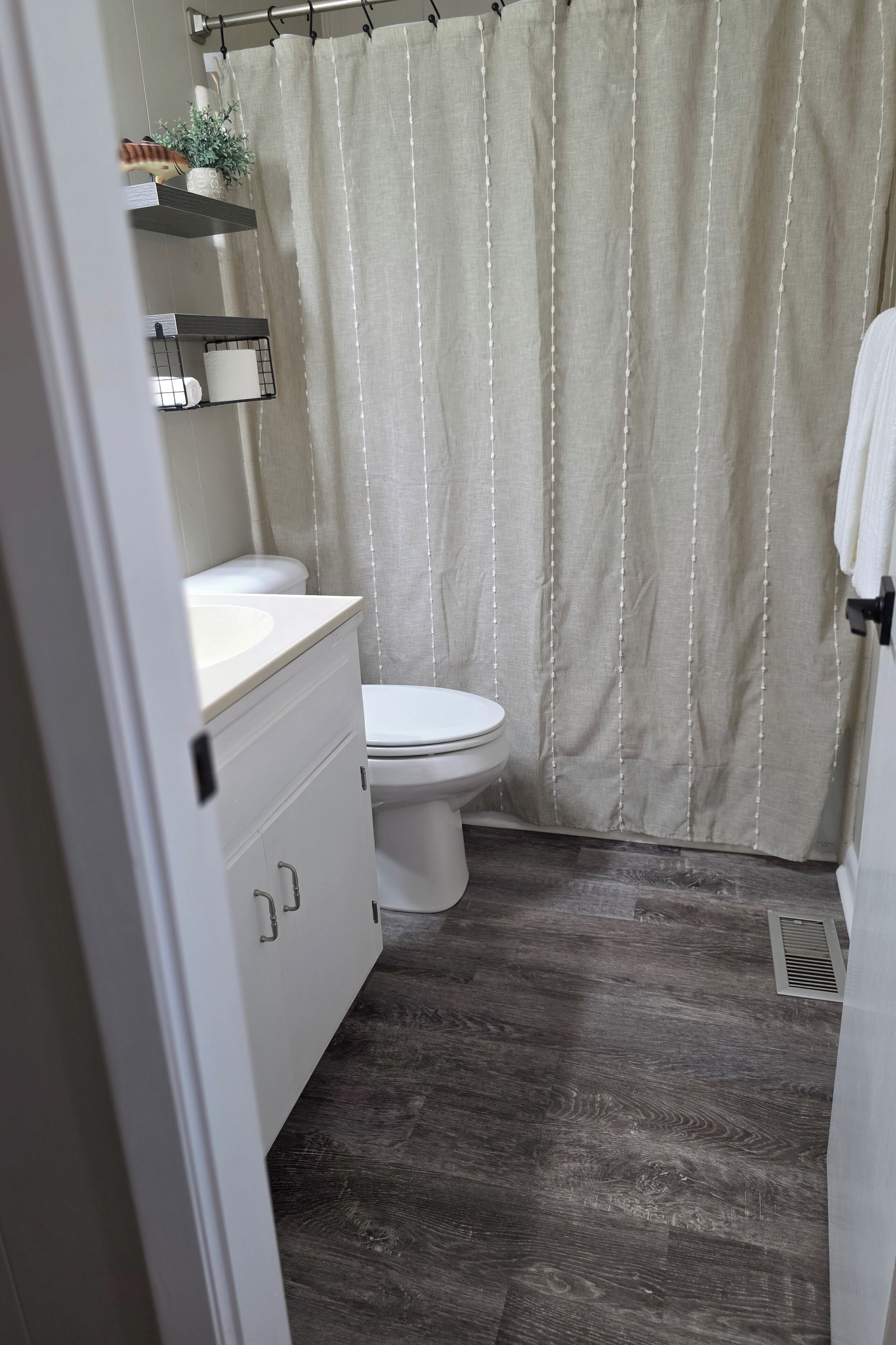 Ein Badezimmer mit Toilette, Waschbecken und Duschvorhang.